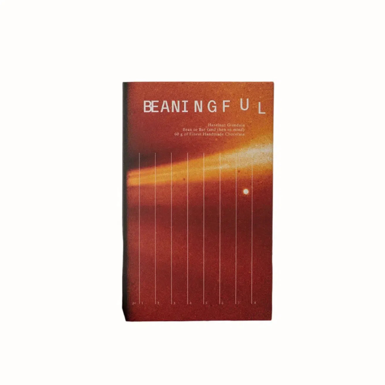A bar of dark chocolate with hazelnut gianduja, featuring a minimalist, artistic packaging design with a bold "BEANINGFUL" logo. The chocolate bar is presented in a clean, numbered design, and the background features a warm, hazelnut-colored gradient with subtle texture.