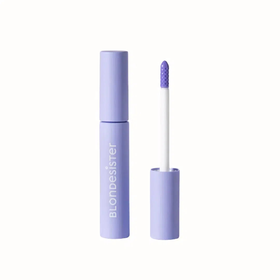A lip gloss from Blondesister featuring a sleek, pastel purple packaging with the brand name embossed on the side. The product includes a white applicator wand with a textured tip, designed for smooth application. The gloss offers a shiny, subtle color, perfect for adding a light layer of shine to the lips.