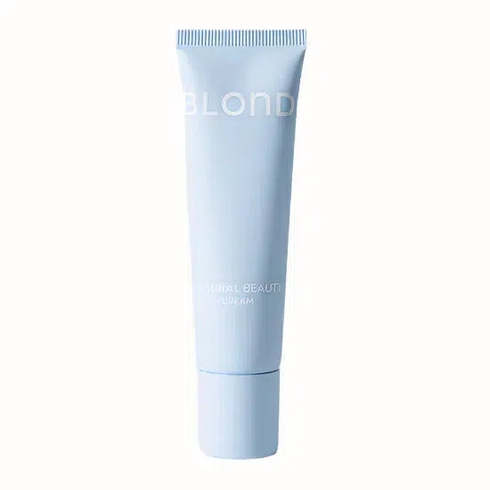 A tube of 2-in-1 Natural Beauty Tinted Cream by BLOND. The soft blue packaging features minimalist white text, with the product designed to provide both hydration and light coverage. The tinted cream is intended to enhance natural beauty, offering a radiant, even complexion with a fresh, luminous finish, perfect for everyday use.