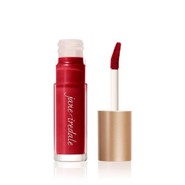 A tube of Jane Iredale Lip Gloss in a soft pink shade with a glossy finish, accompanied by a precise, doe-foot applicator for easy application. This lip gloss provides a smooth texture and a natural, hydrated look, perfect for everyday wear. The sleek, gold-colored packaging adds a touch of elegance to your beauty routine.