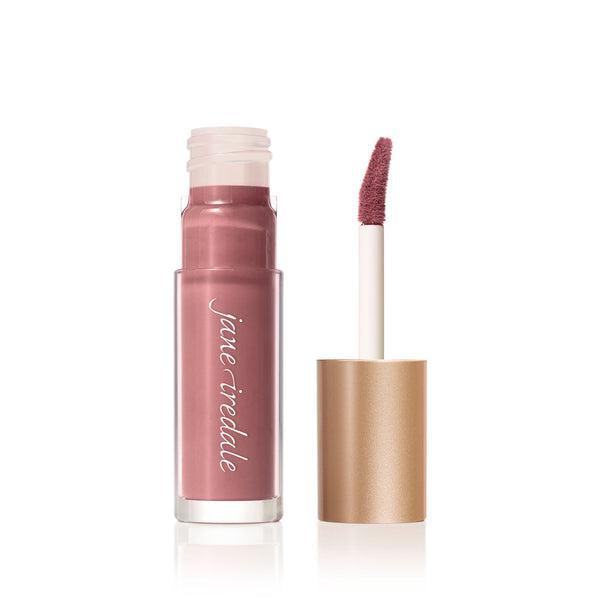 A tube of Jane Iredale Lip Gloss in a soft pink shade with a glossy finish, accompanied by a precise, doe-foot applicator for easy application. This lip gloss provides a smooth texture and a natural, hydrated look, perfect for everyday wear. The sleek, gold-colored packaging adds a touch of elegance to your beauty routine.