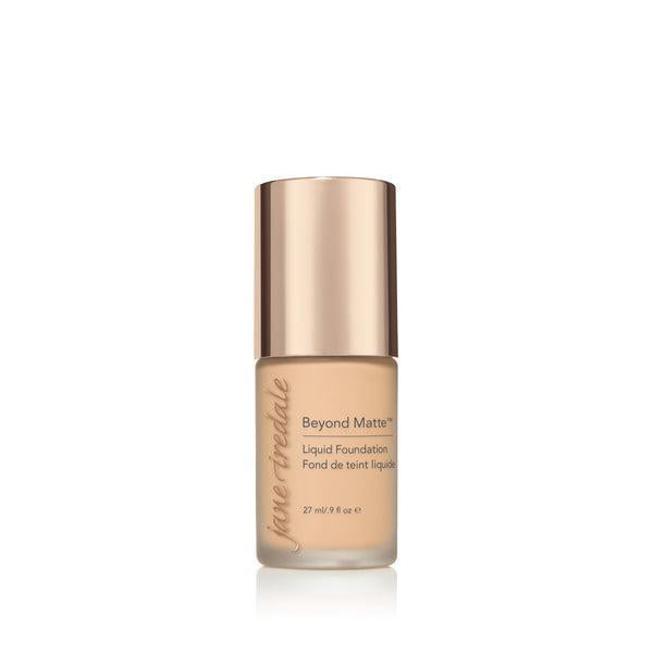 A bottle of Jane Iredale Beyond Matte Liquid Foundation with a soft beige tone, designed for a flawless, matte finish. The foundation provides long-lasting coverage and a smooth appearance, perfect for controlling oil and creating a matte, even complexion. The elegant packaging with a rose-gold cap offers a luxurious touch to your beauty essentials.