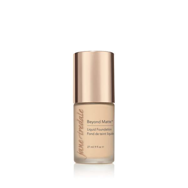 A bottle of Jane Iredale Beyond Matte Liquid Foundation with a soft beige tone, designed for a flawless, matte finish. The foundation provides long-lasting coverage and a smooth appearance, perfect for controlling oil and creating a matte, even complexion. The elegant packaging with a rose-gold cap offers a luxurious touch to your beauty essentials.