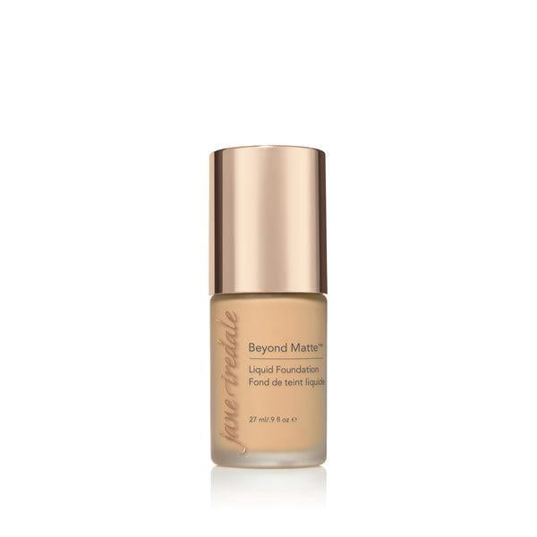 A bottle of Jane Iredale Beyond Matte Liquid Foundation with a soft beige tone, designed for a flawless, matte finish. The foundation provides long-lasting coverage and a smooth appearance, perfect for controlling oil and creating a matte, even complexion. The elegant packaging with a rose-gold cap offers a luxurious touch to your beauty essentials.
