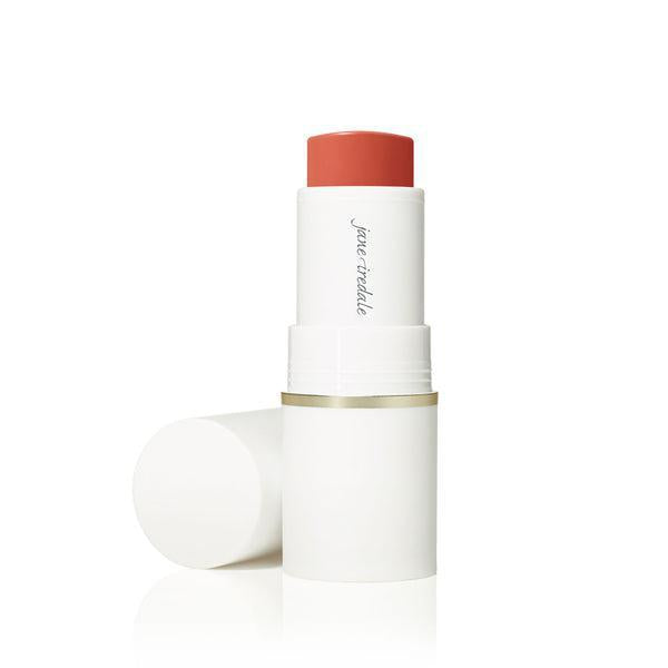 A stick of Jane Iredale Glow Time™ Pieštukiniai skaistalai. The blush is housed in a sleek white tube with a gold accent at the base. The product offers a rich, warm hue, ideal for creating a glowing, radiant flush on the cheeks.