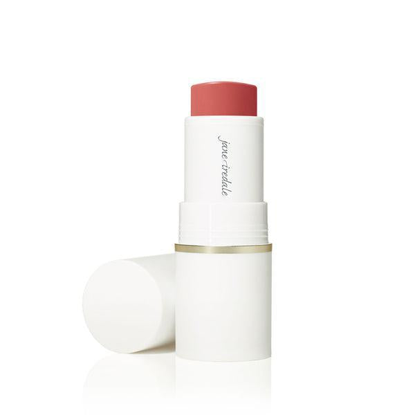A stick of Jane Iredale Glow Time™ Pieštukiniai skaistalai. The blush is housed in a sleek white tube with a gold accent at the base. The product offers a rich, warm hue, ideal for creating a glowing, radiant flush on the cheeks.
