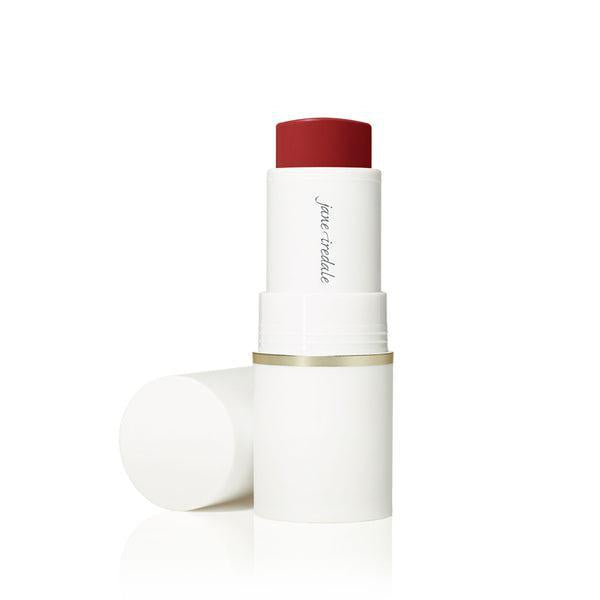 A stick of Jane Iredale Glow Time™ Pieštukiniai skaistalai. The blush is housed in a sleek white tube with a gold accent at the base. The product offers a rich, warm hue, ideal for creating a glowing, radiant flush on the cheeks.