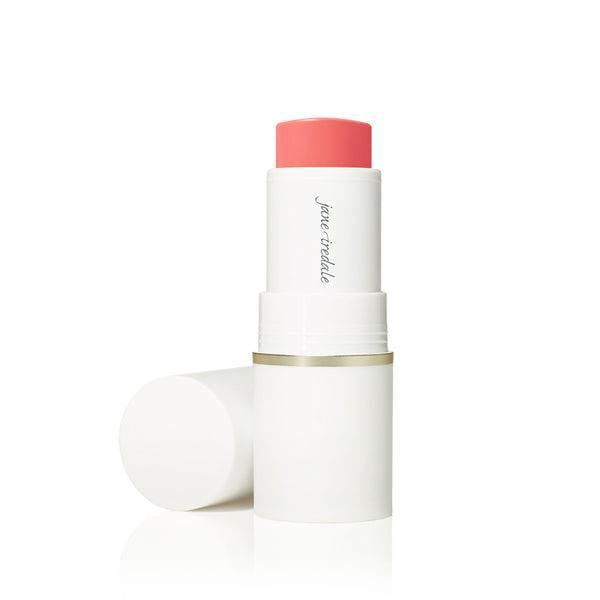 A stick of Jane Iredale Glow Time™ Pieštukiniai skaistalai. The blush is housed in a sleek white tube with a gold accent at the base. The product offers a rich, warm hue, ideal for creating a glowing, radiant flush on the cheeks.