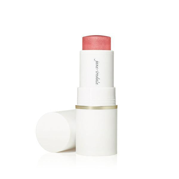A stick of Jane Iredale Glow Time™ Pieštukiniai skaistalai. The blush is housed in a sleek white tube with a gold accent at the base. The product offers a rich, warm hue, ideal for creating a glowing, radiant flush on the cheeks.