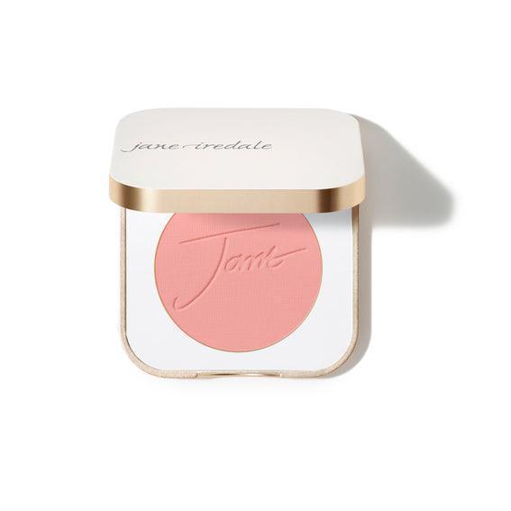 Jane Iredale Blush
A compact case of Jane Iredale blush featuring a soft peachy-pink powder with the brand's name embossed on the surface. The compact is square-shaped with a gold trim and contains a generous amount of product.