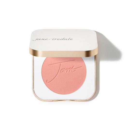 Jane Iredale Blush
A compact case of Jane Iredale blush featuring a soft peachy-pink powder with the brand's name embossed on the surface. The compact is square-shaped with a gold trim and contains a generous amount of product.