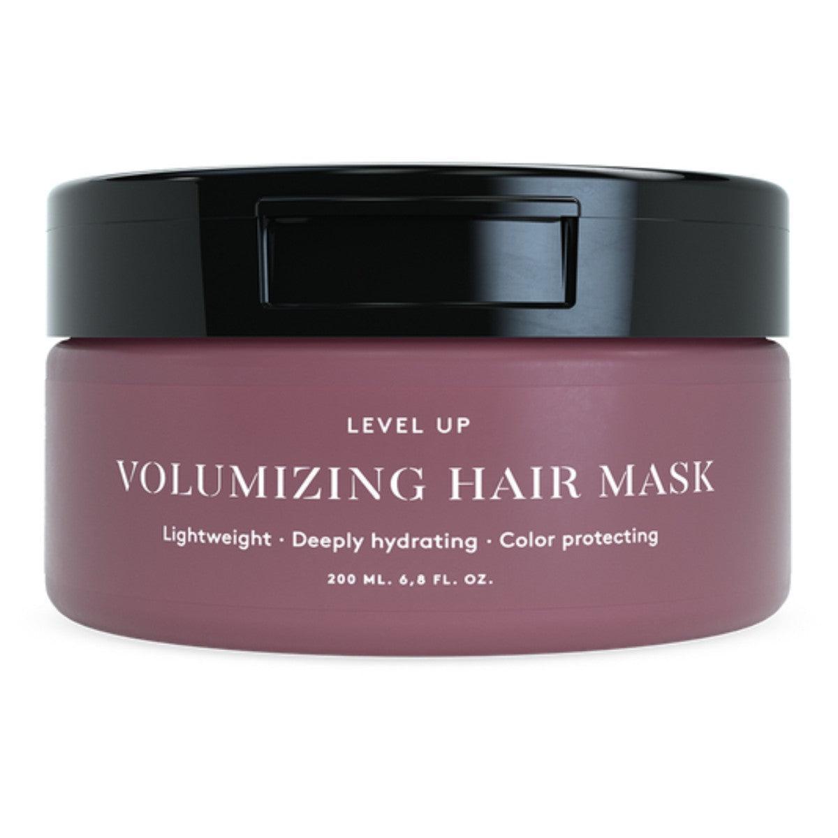 Volumizing Hair Mask
A 200 ml jar of Level Up Volumizing Hair Mask with a pink label, highlighting its lightweight, deeply hydrating, and color-protecting properties. The packaging features white text detailing the mask's key benefits: "Lightweight," "Deeply hydrating," and "Color protecting."