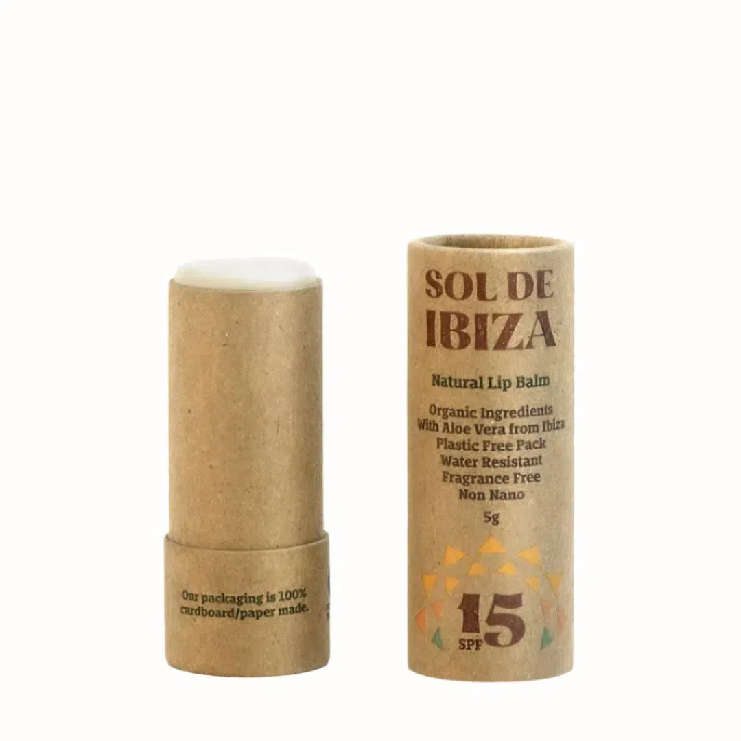 This is a Sol de Ibiza Natural Lip Balm in a cardboard tube packaging, with SPF 15. The product is marketed as having organic ingredients, including Aloe Vera sourced from Ibiza. The lip balm is presented in eco-friendly packaging that is 100% paper/cardboard and is water-resistant, fragrance-free, and non-nano. The net weight of the lip balm is 5g.