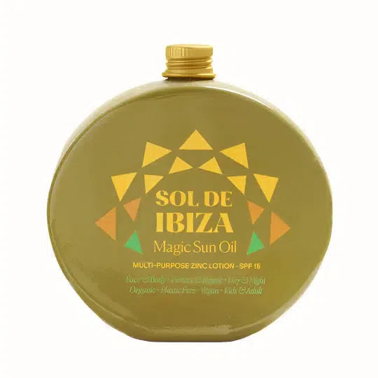 
A bottle of Sol de Ibiza Magic Sun Oil featuring a bold design with geometric shapes in orange, yellow, and green. The product is labeled as a multi-purpose zinc lotion with SPF 15, offering protection for both face and body, and is suitable for use during both day and night. The formula is organic, vegan, plastic-free, and suitable for kids and adults. The product emphasizes its environmentally friendly packaging and its ability to protect and repair skin.